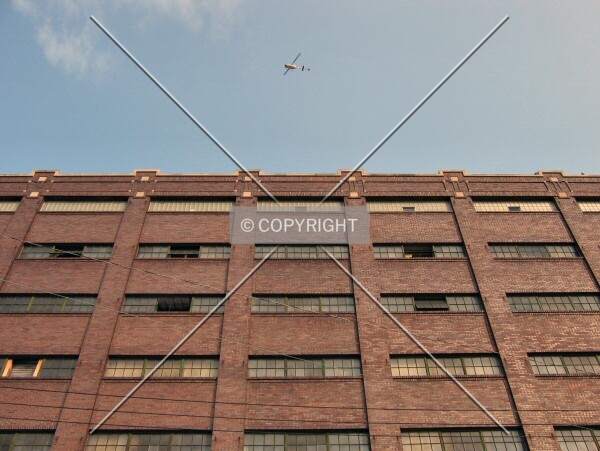 Looking up the 7th Avenue North facade, with a helicopter