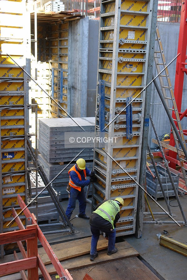 Construction workers applying formwork