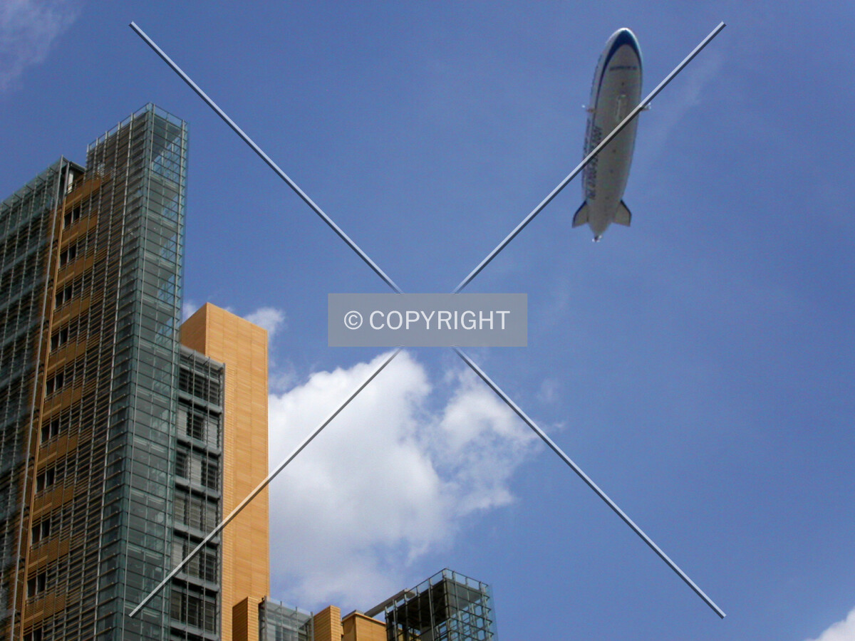 A zeppelin flying over the building