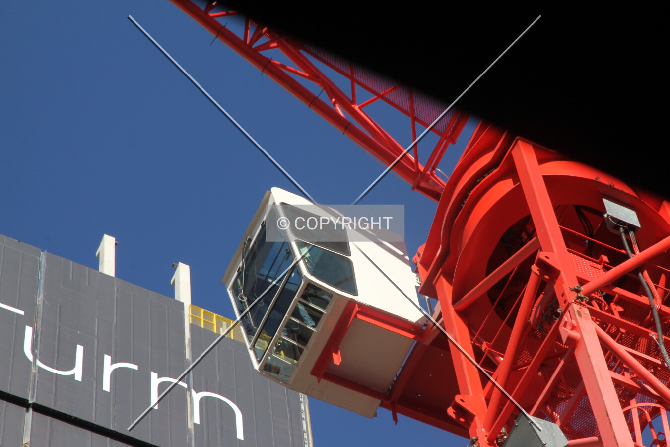 The cockpit of the red construction crane