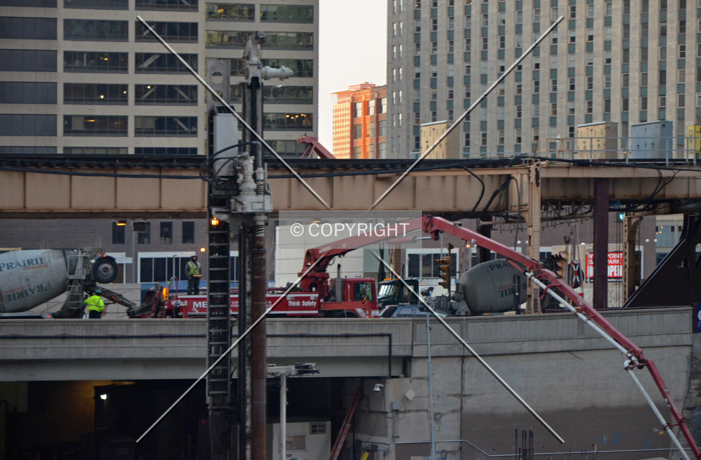 Boom of a concrete pump extended from Lake Street during the foundation mat pour; February 14, 2015.