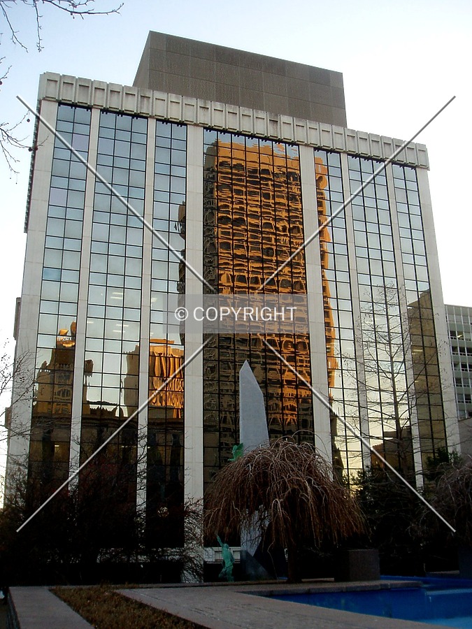 The Kerr McGee Center reflects off the north side, from Robert S. Kerr Avenue