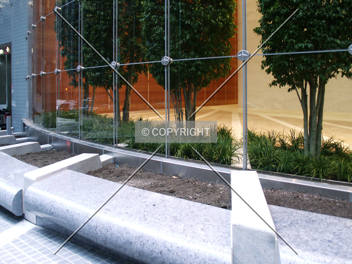 Landscaping beds in front of the lobby wall on Monroe Street