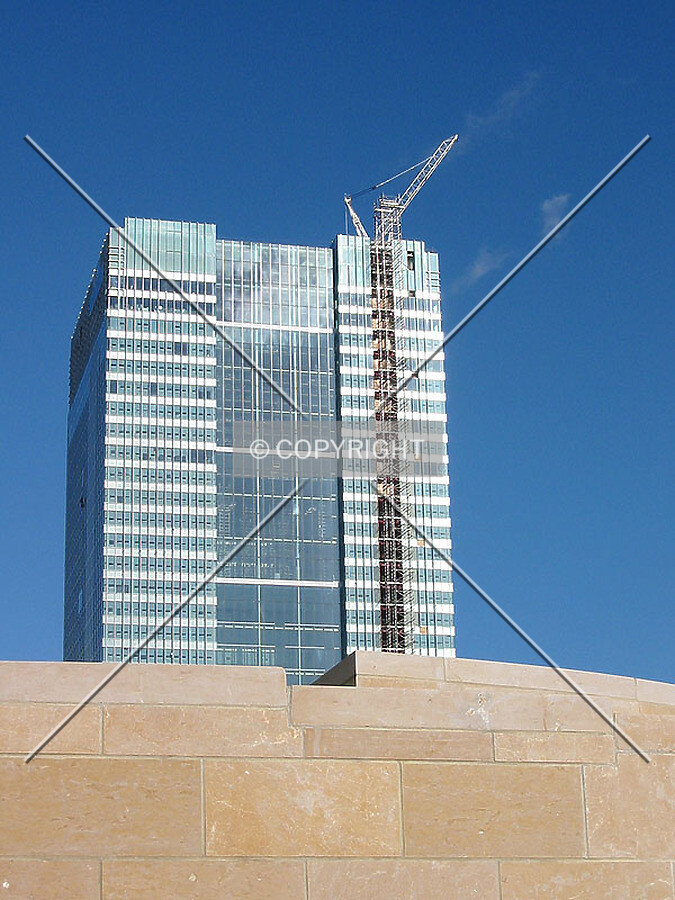 The tower's upper portion rises over landscaping at South Quay