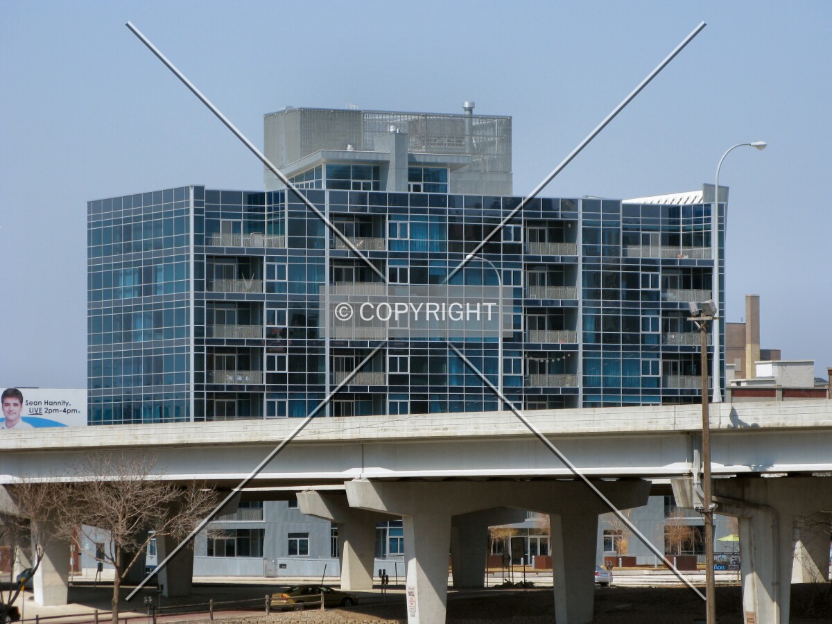 Distant view to the north from 5th Street North, top floors rising beyond the 4th Street onramp to Interstate 94 West