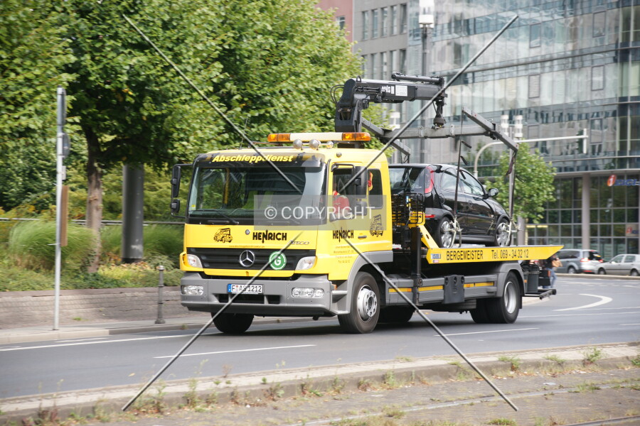Tow truck carrying away a car