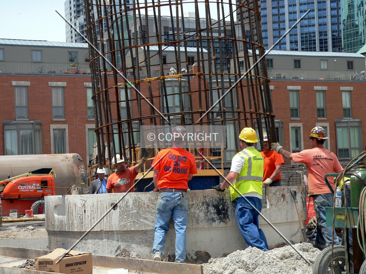 Lowering a rebar cage into a caisson hole