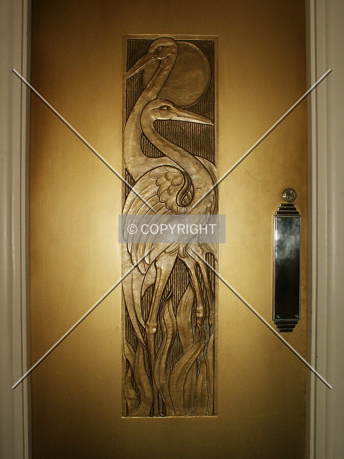 Brass cranes on a door off the lobby