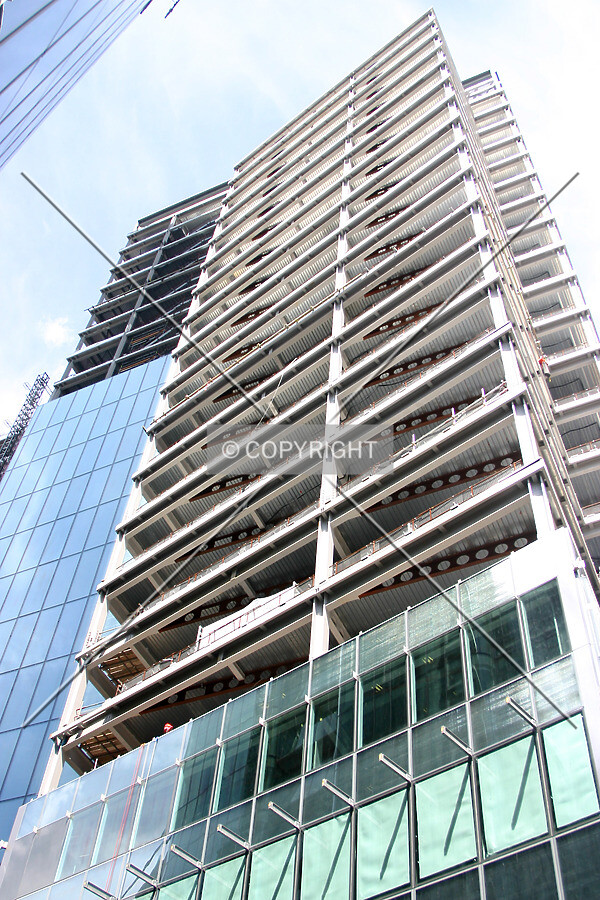 Looking up from Ropemaker Street showing façade installation progress to the south side