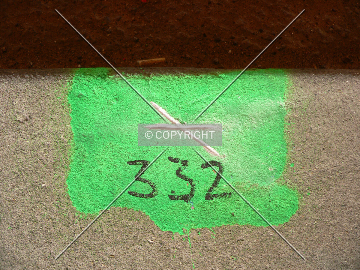 Settlement mark on the curb of lower Lake Shore Drive
