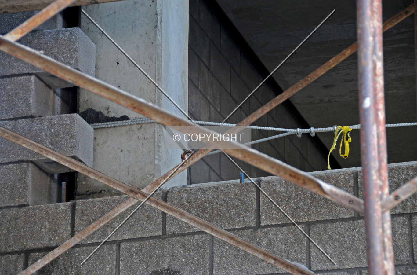Installation of concrete masonry block on the lower floors of the north facade