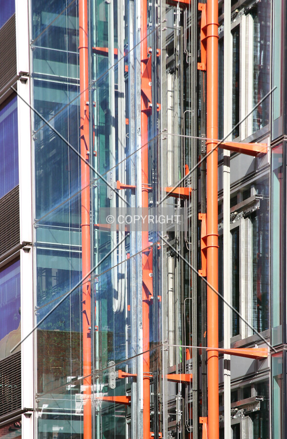 View into the glazed lift shaft showing the exposed steel in classic Rogers bold colours