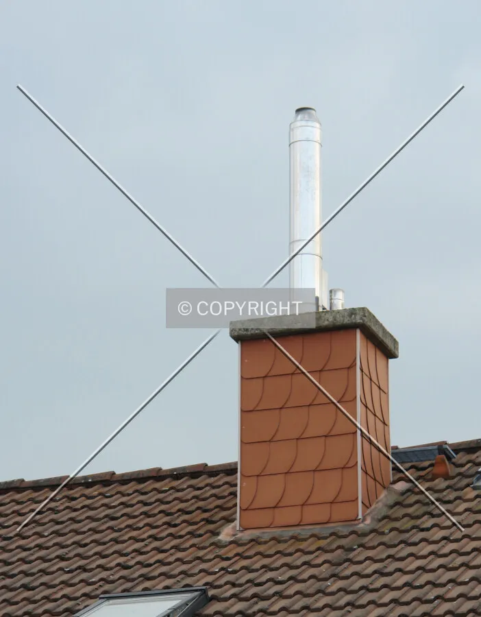 Smoke stack and pipe ontop of a roof