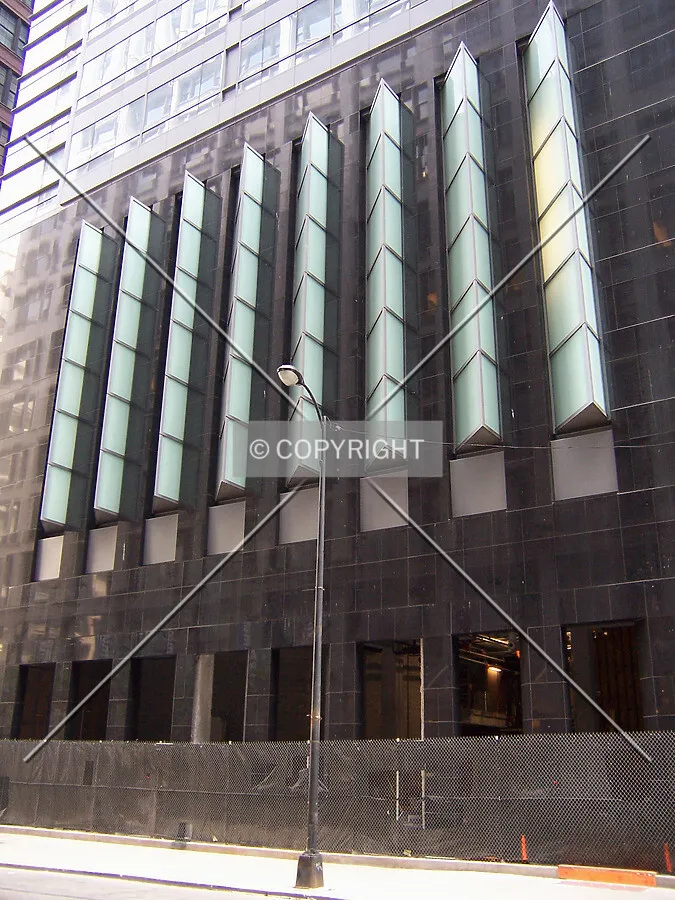 Triangular bay windows extending outward from the north facade of the base