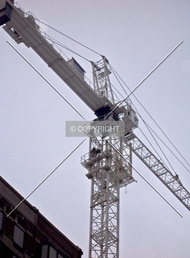 Looking up from Rush Street; a section of the tower crane shaft is being added in a crane jump