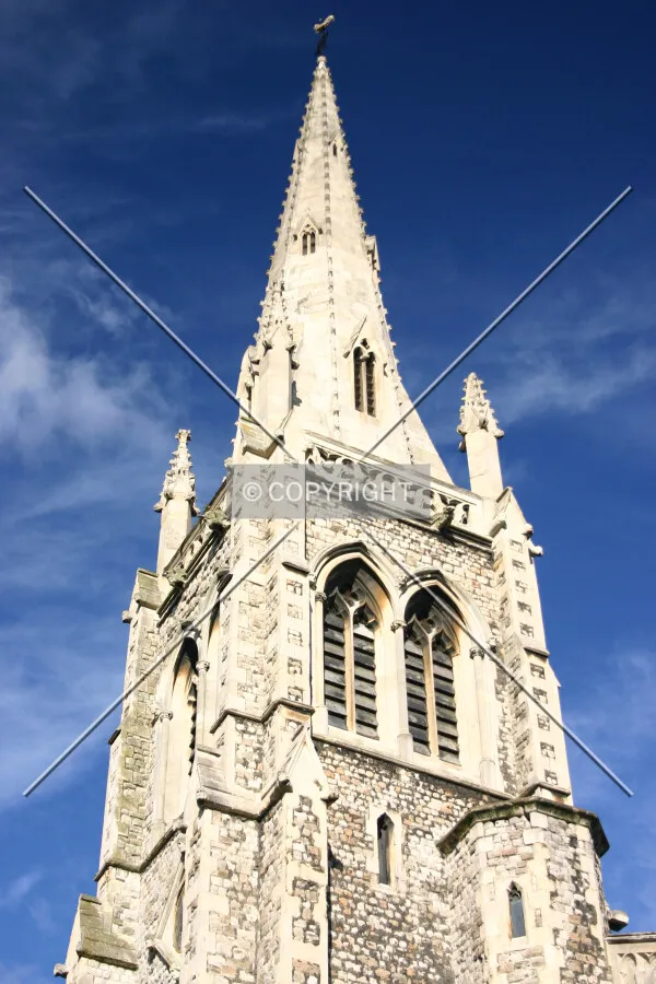 Looking up at the pinnacled tower and spire
