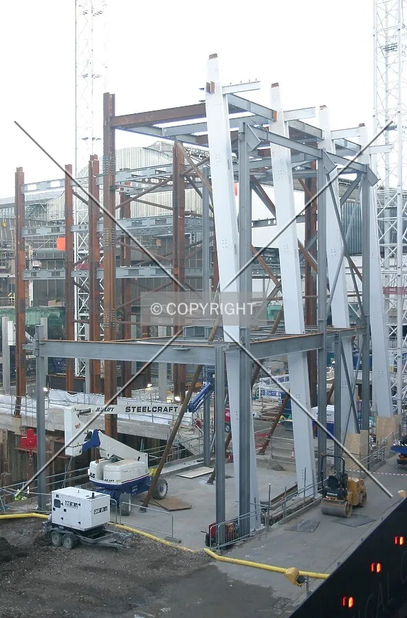 Elevated view northeast of the emerging steel frame and inclined perimeter columns