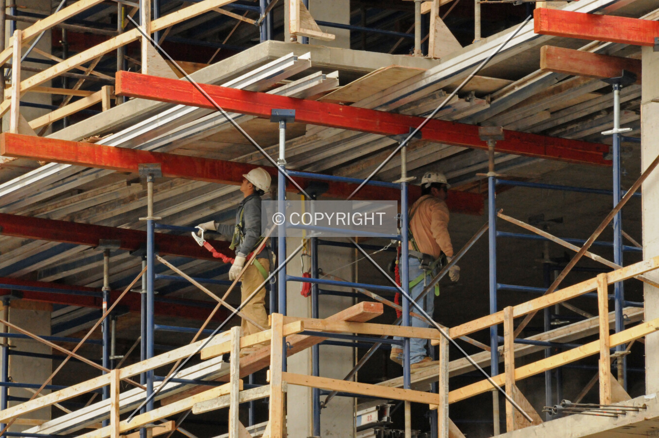 Scaffolding and temporary decking holding concrete slabs of the podium's western edge in place while it cures
