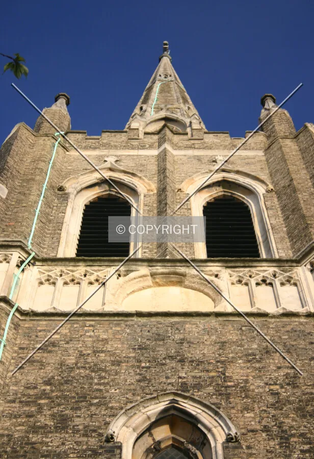 Looking up at the top of the tower and spire