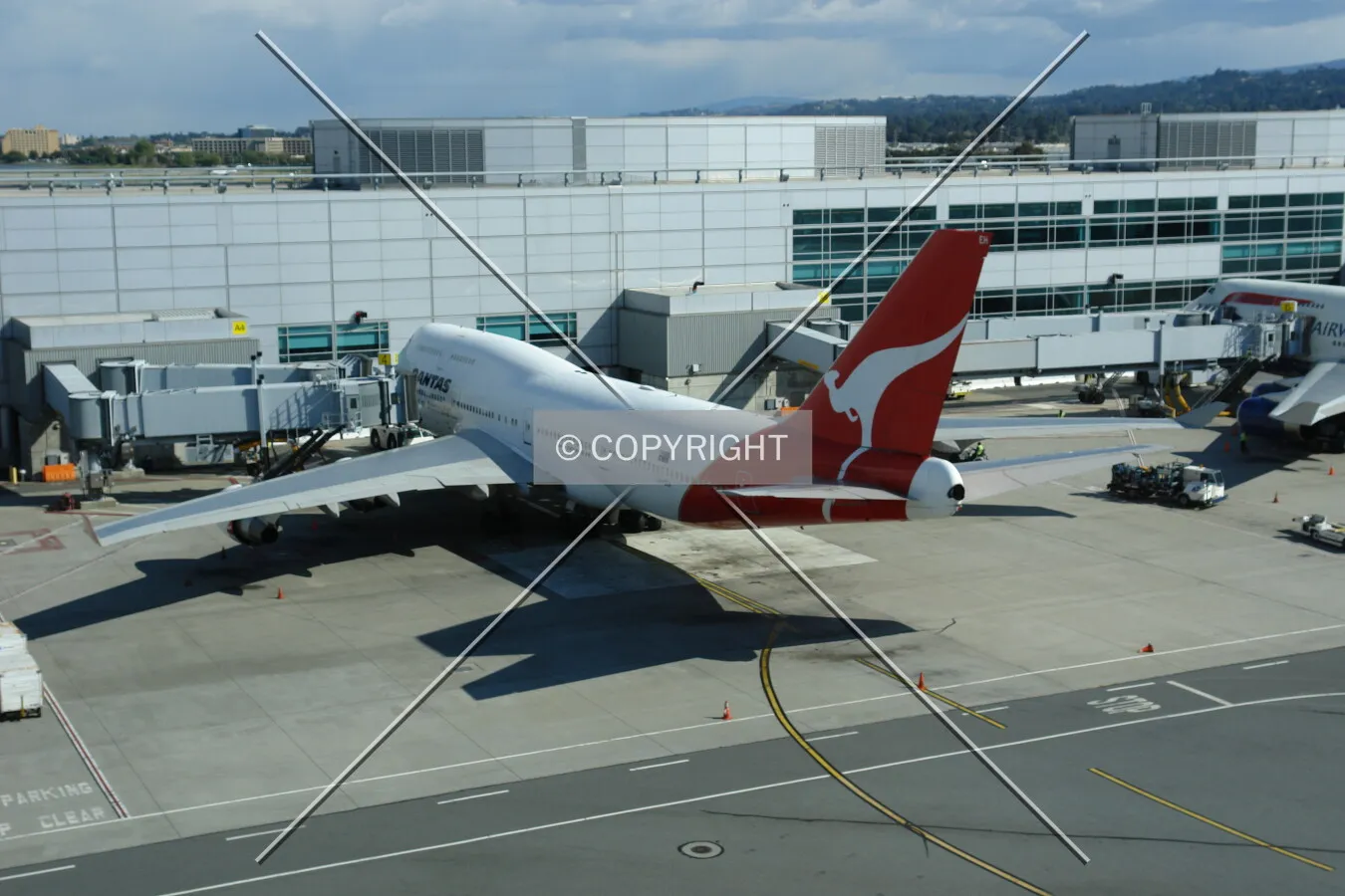 Quantas aircraft docked to a passenger terminal
