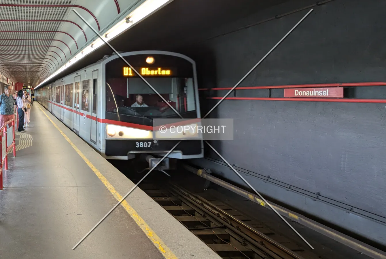 U1 train arriving at the Donauinsel station beneath the main bridge deck