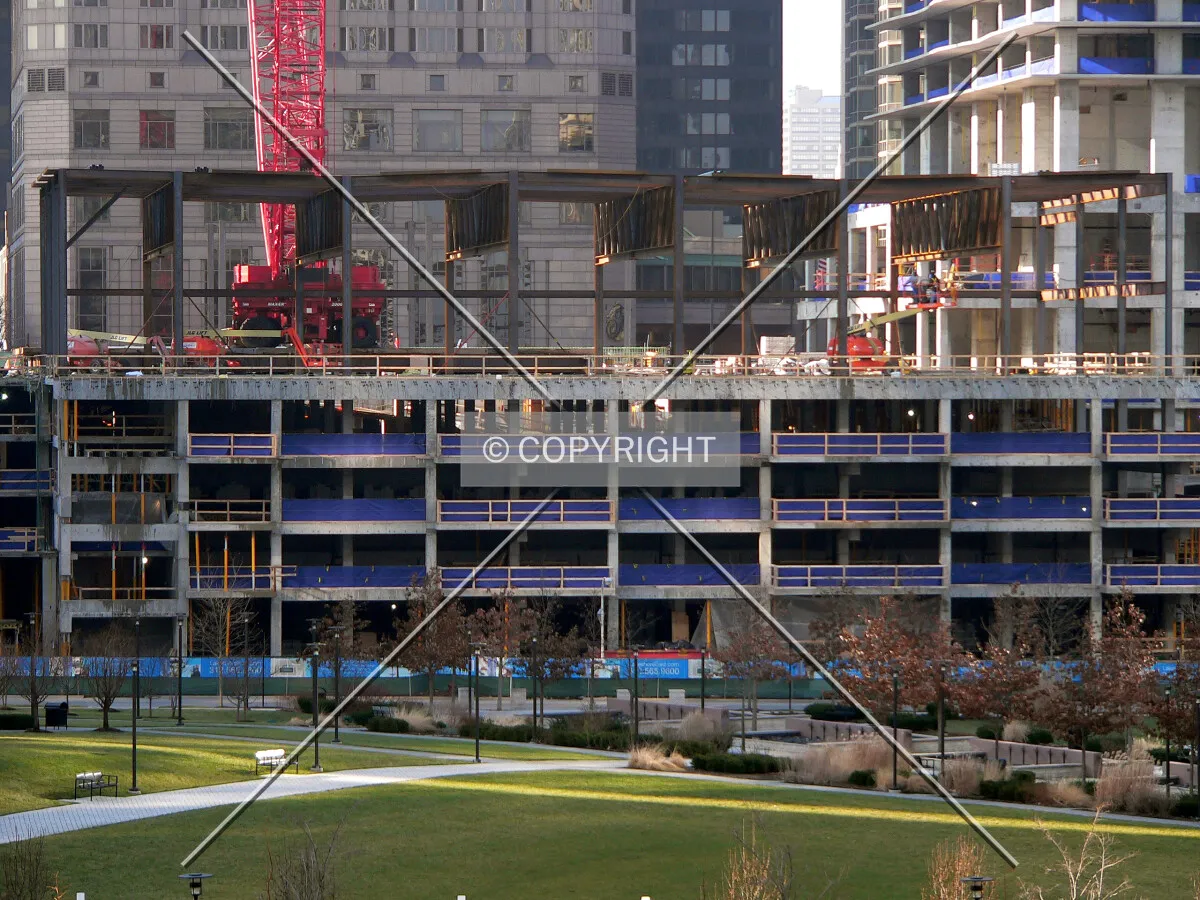 View to the west of townhomes lining the parking structure with structural steel for the ballroom being installed