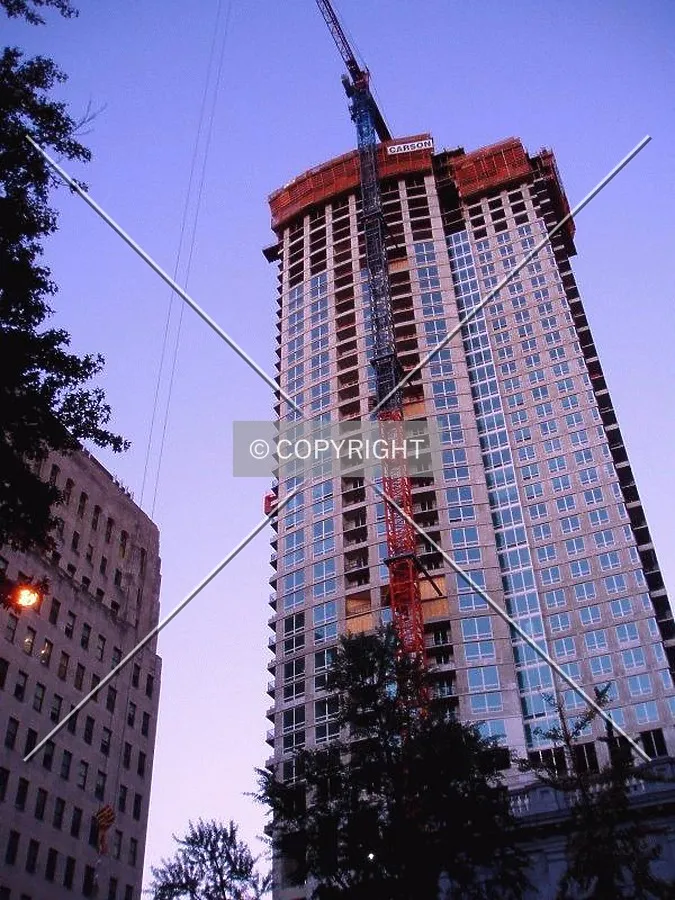 The crane boom extends to the east over Washington Square for an early morning lift