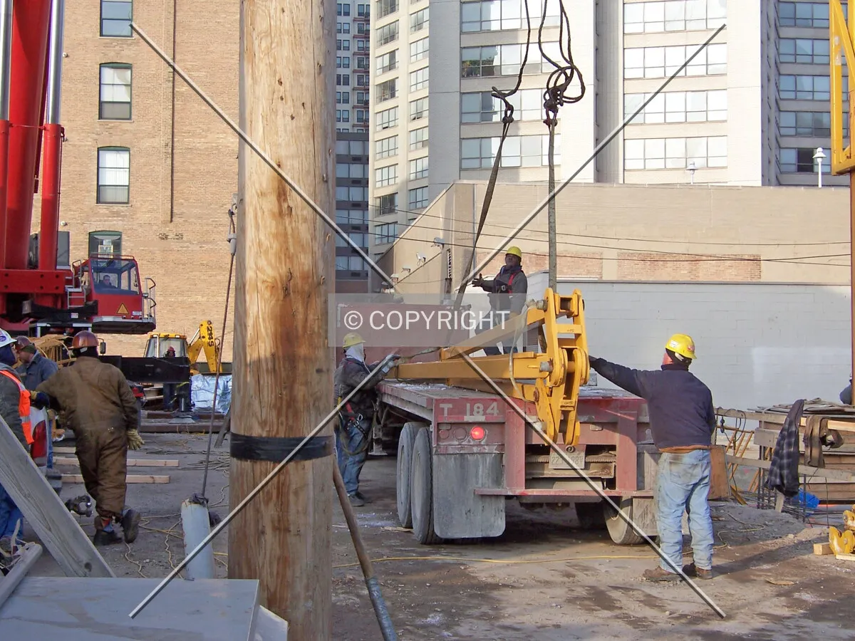 Preparing to hoist the peak of the tower crane from the flat bed truck