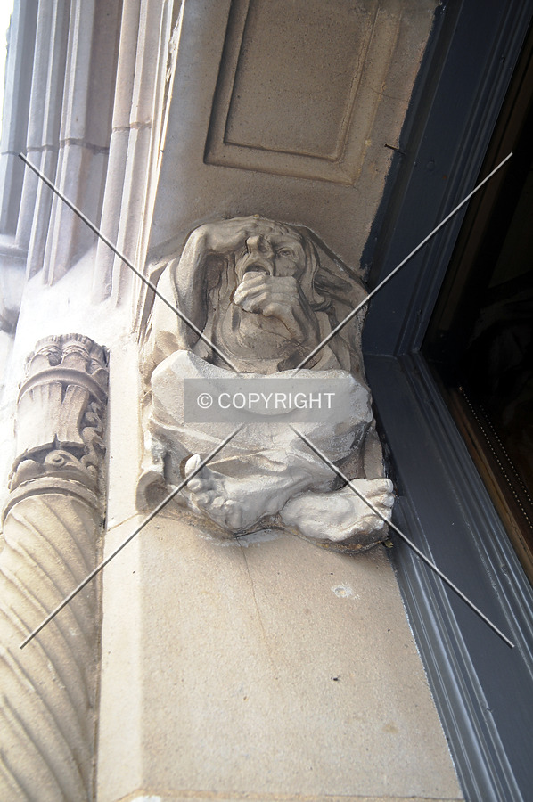 Looking up at ornamentation above the first floor windows