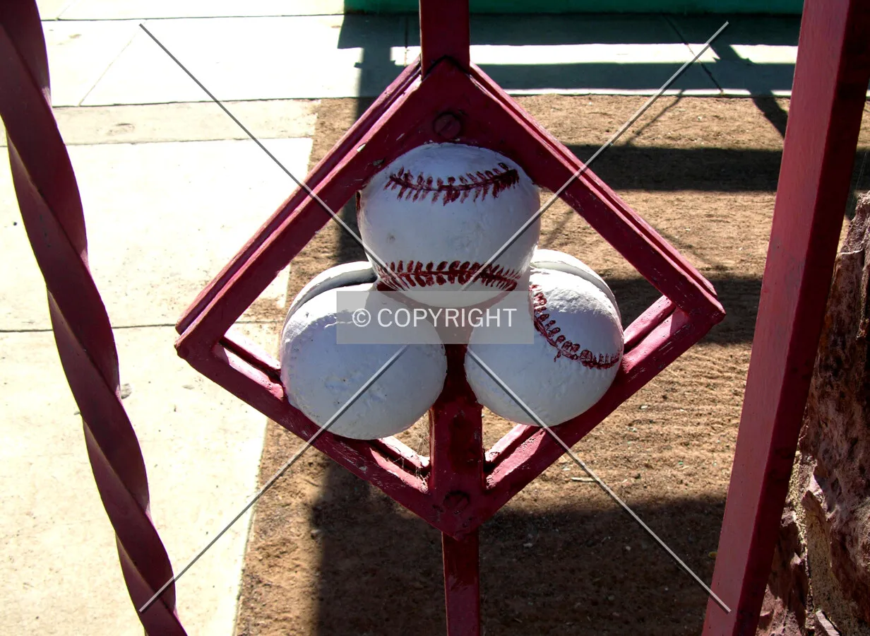 Baseballs embedded in the 1st base gate