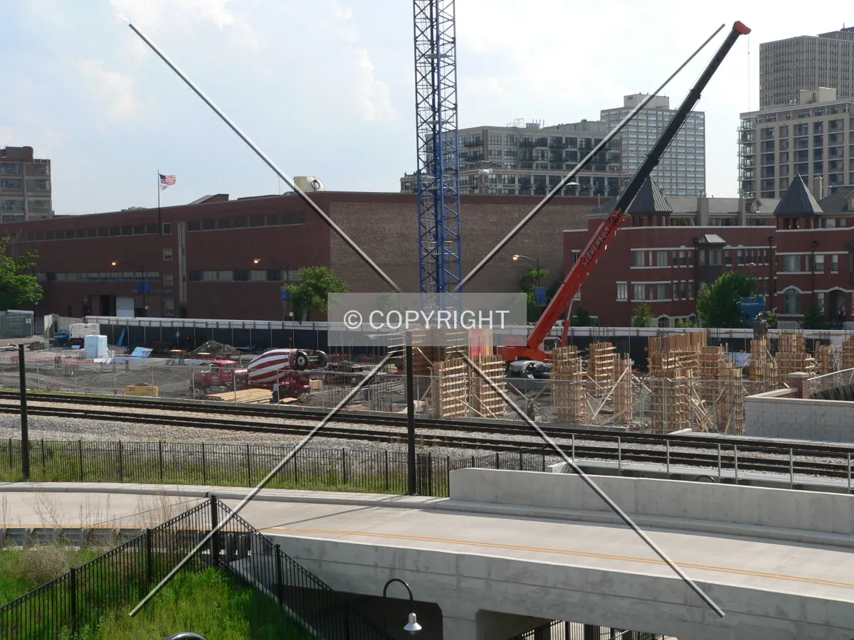 Looking west across the construction site from the bridge that crosses the tracks