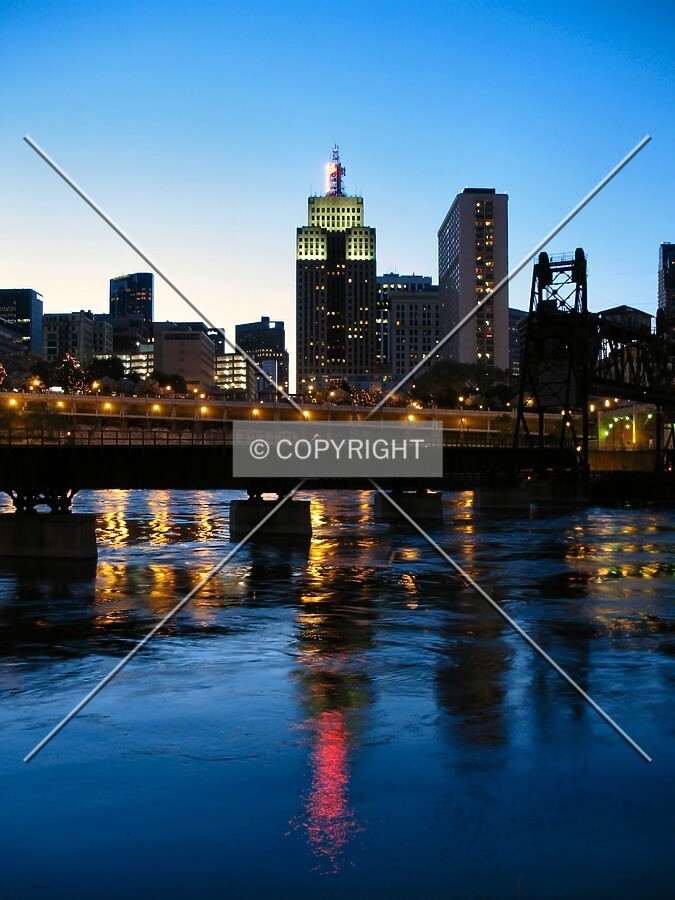Reflected in the Mississippi River at dusk, in skyline context