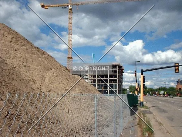 View to the north along Lyndale Avenue, tower rising behind pile of sand