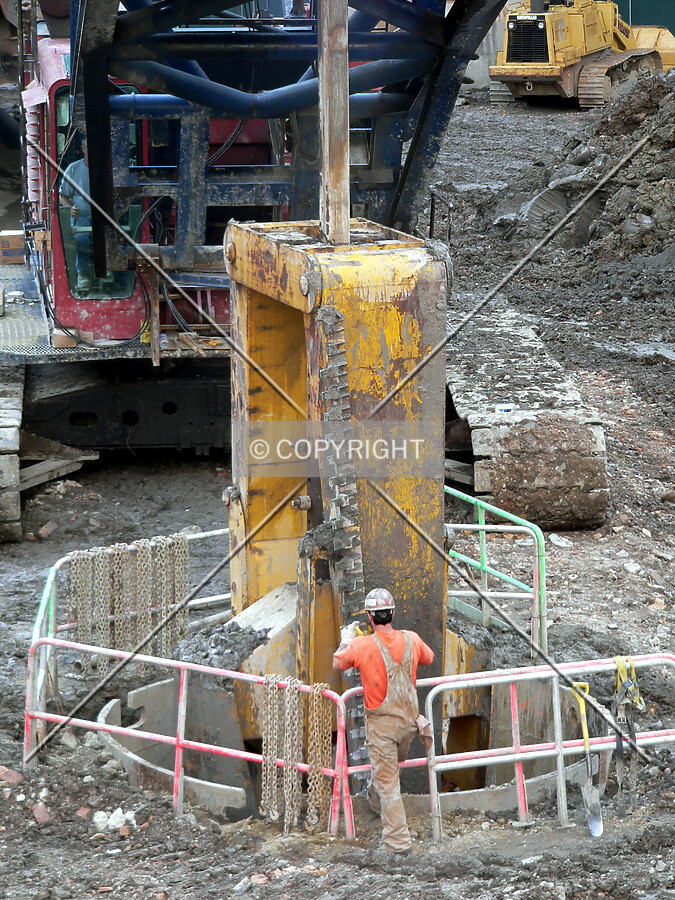 Lowering a caisson bucket in order to remove more clay