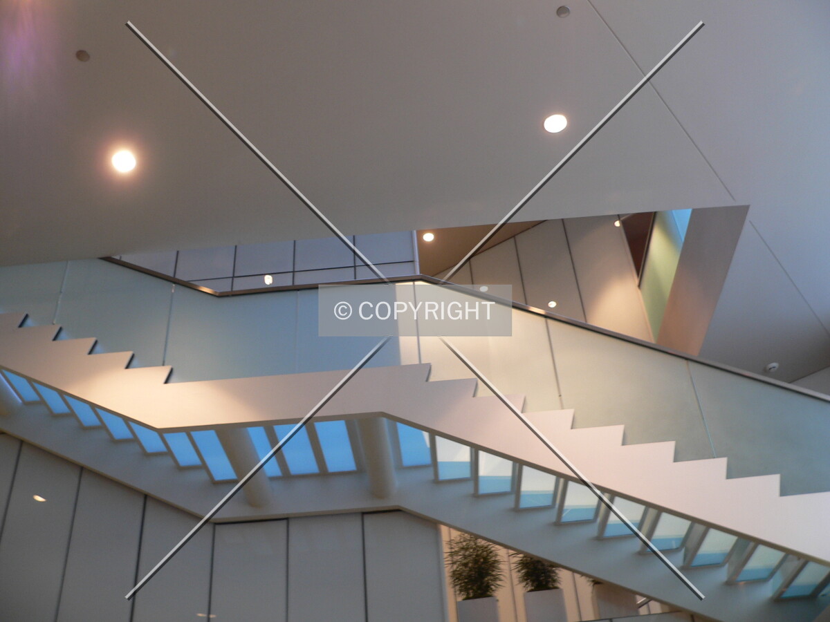 Looking up at a staircase that leads from the second floor to the third floor