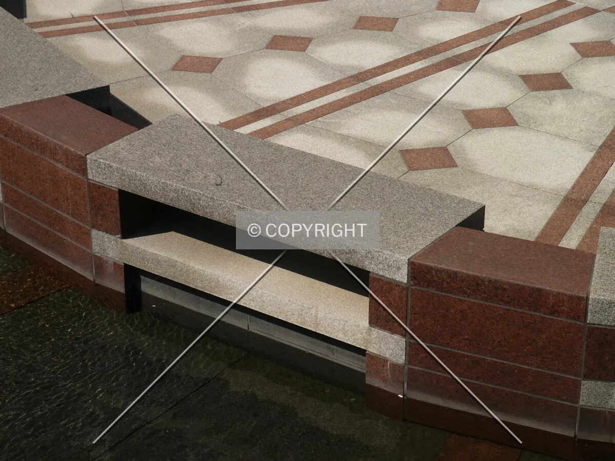 Granite bench on the island in the front plaza