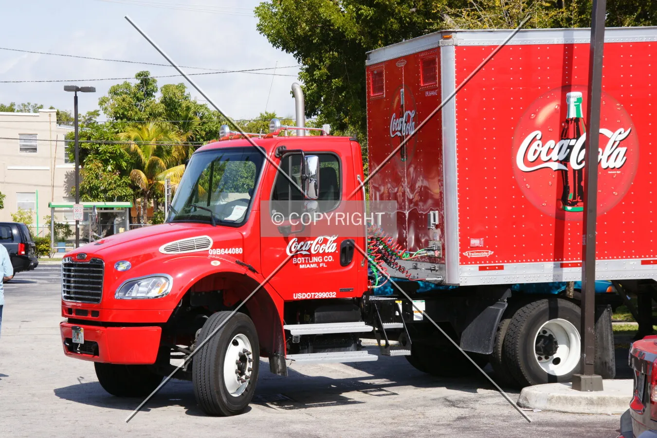 A Coke truck is unloading beverages