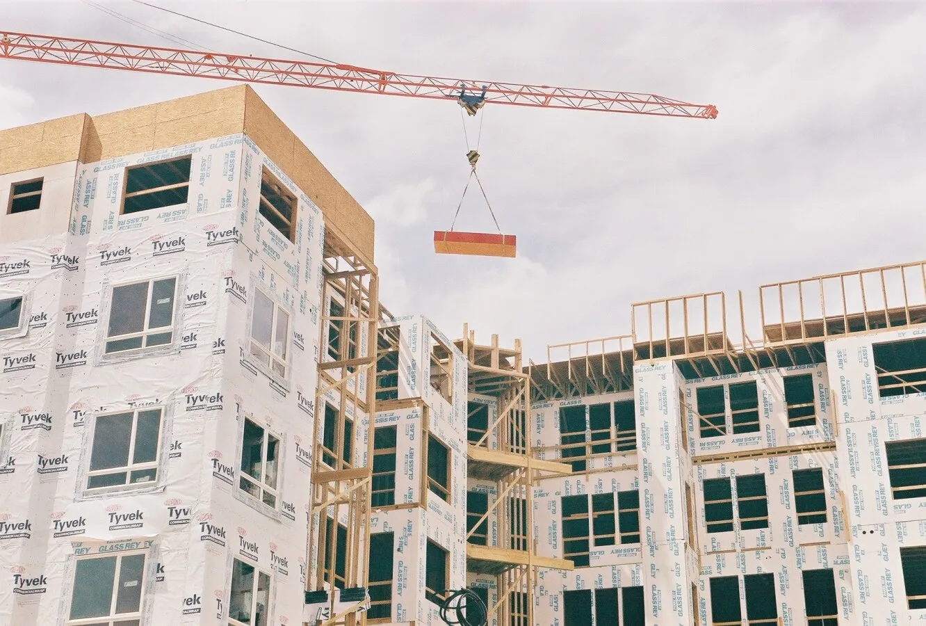 Crane lifting up some lumber