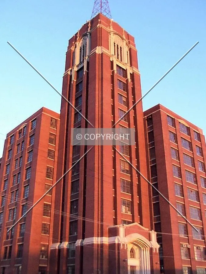 Tower at the northwest corner lit up by an early spring sunset