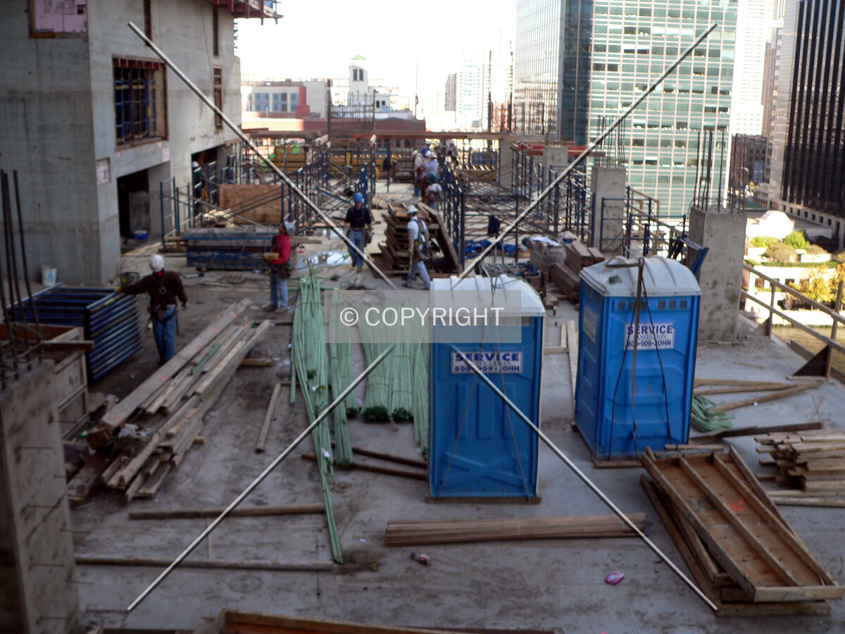 Workers erecting scaffolding for the next level of formwork