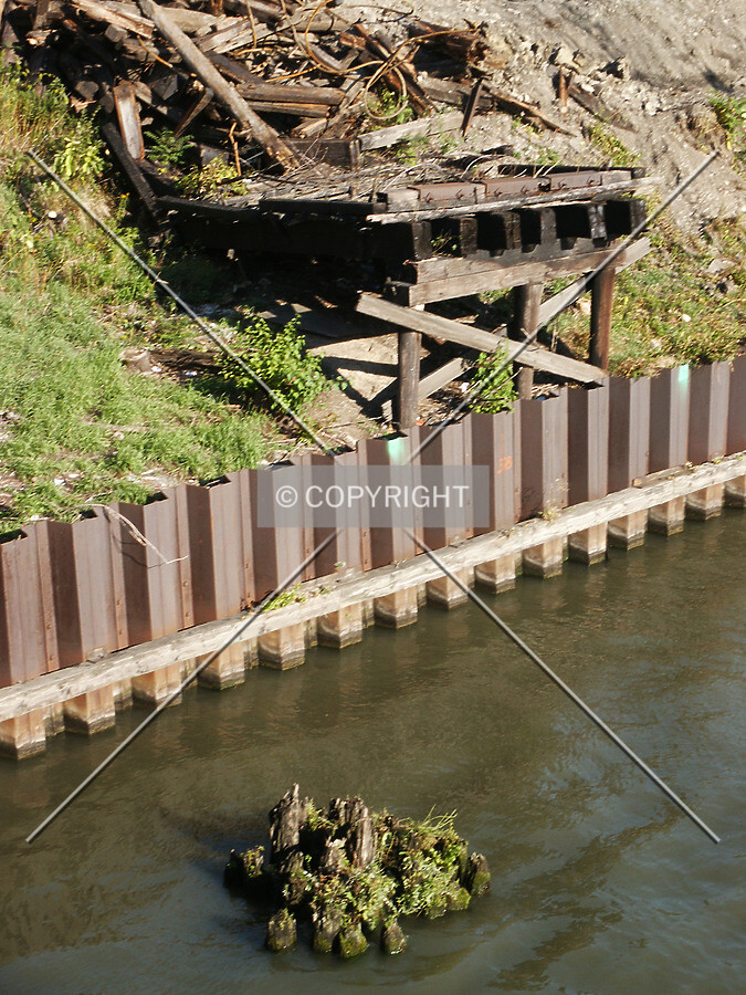 Ruins of a wooden structure by the river, before construction