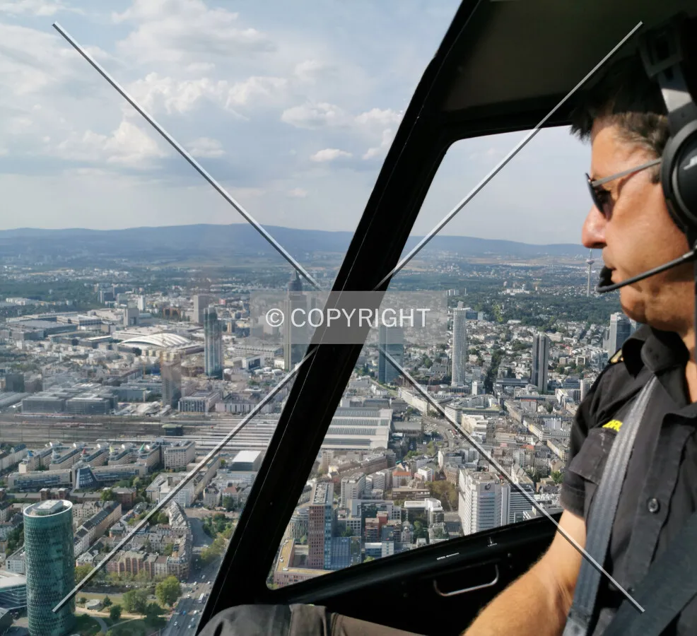 A pilot flying a helicopter