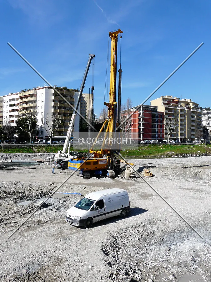 Drilling machine and workers lowering down rebars for a caisson