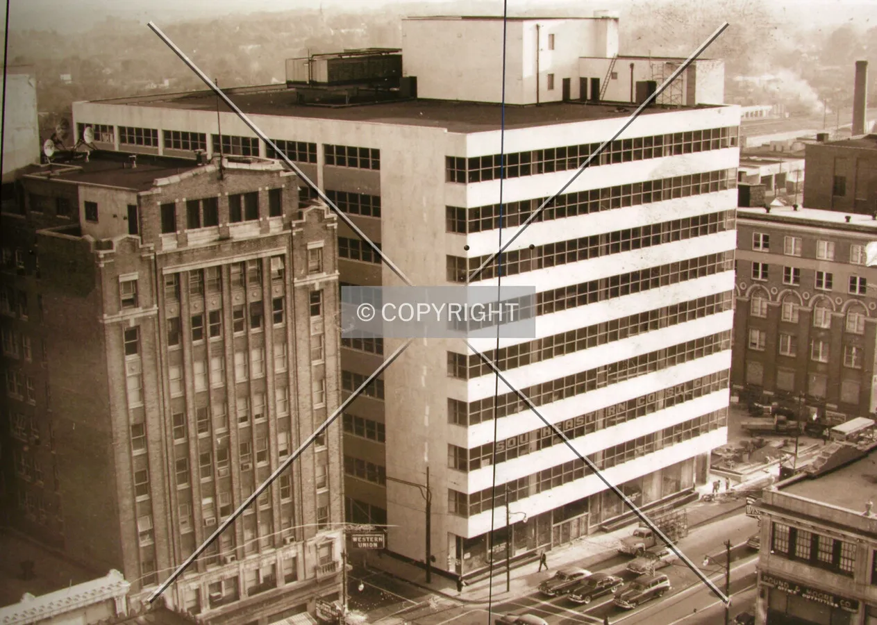 Image taken from the construction barricade at 301 South Tryon, view from the northwest across Tryon Street in 1955 with the demolished Wilder Building to the left