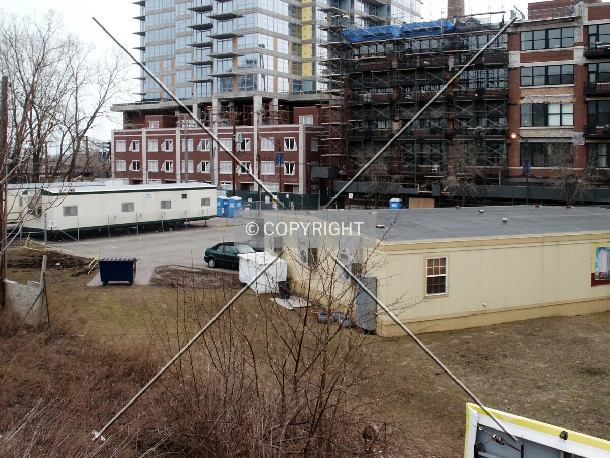 Lower levels from the northwest over the sales center and construction staging area