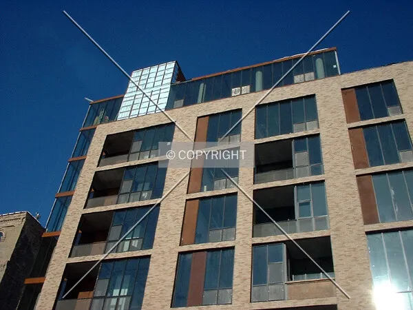 Looking up, from 2nd Street, bright sun reflecting off windows