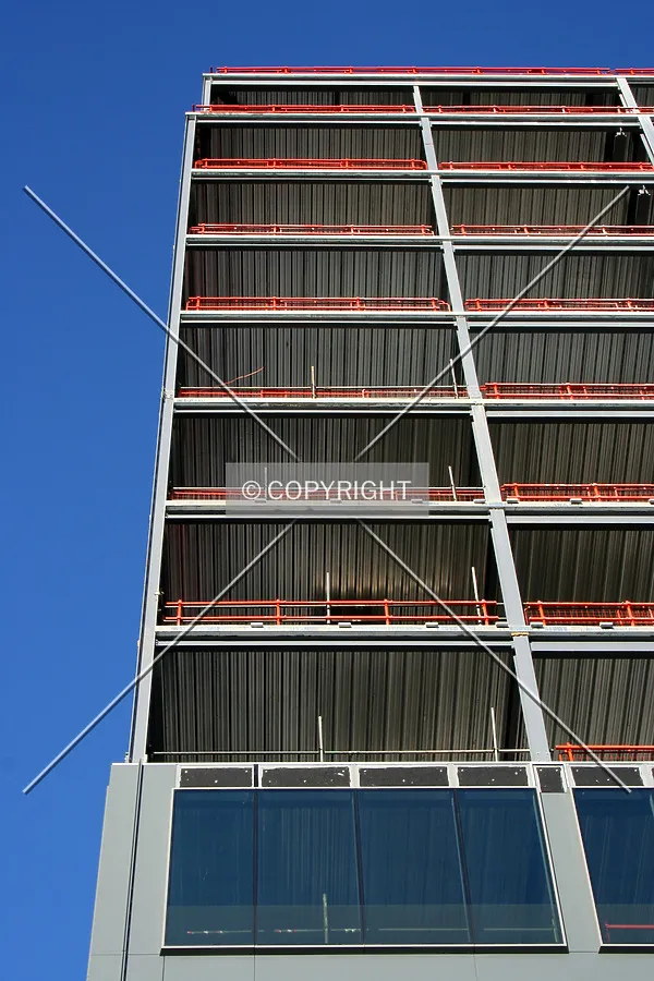 Looking up from the base showing facade progress on the lower levels