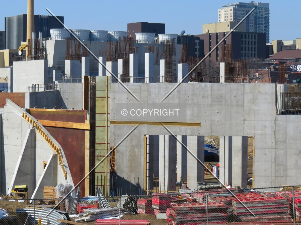 Structural walls and columns rising from the foundation