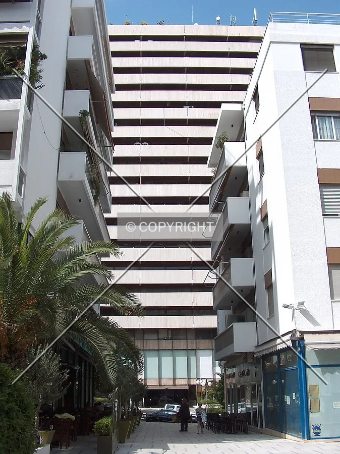 Partial view of the south side of the building as seen amidst two lowrise residential blocks