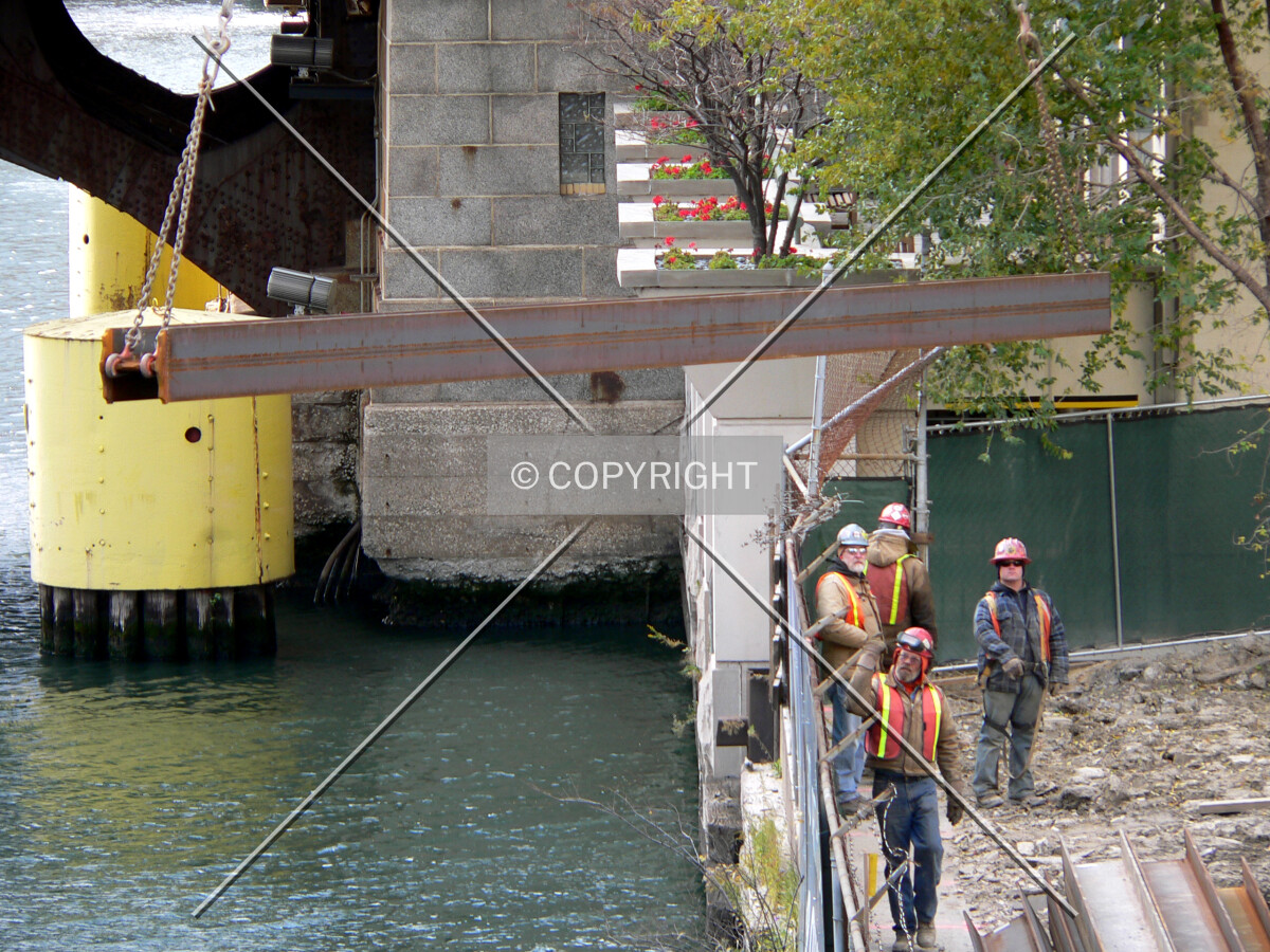 A crane moving a steel beam